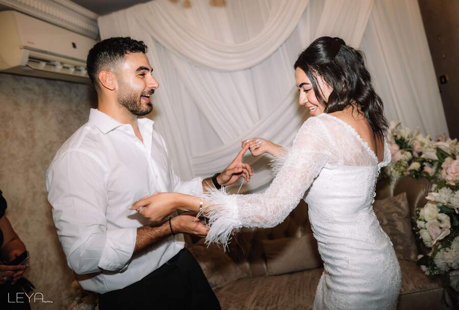Ahmed and Nada laughing together, hands raised