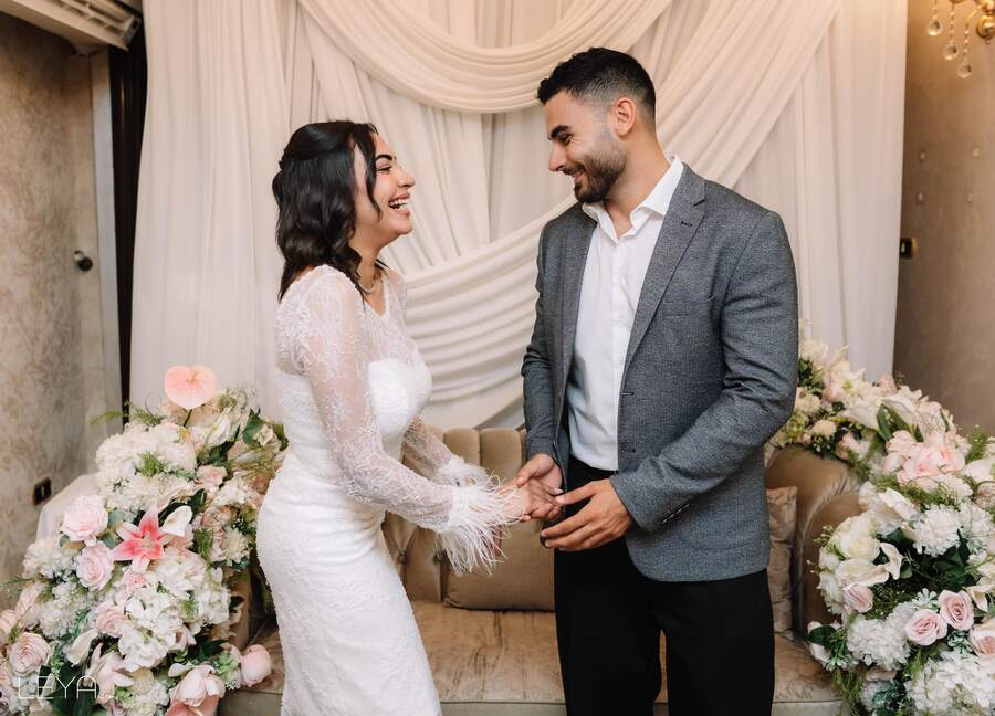 Ahmed and Nada holding hands and smiling
